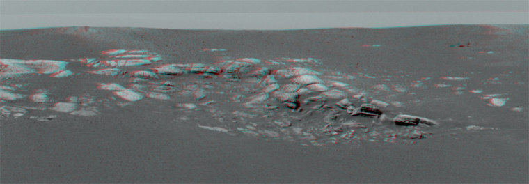 A stereo image taken by Opportunity's panoramic camera shows a layered outcropping of Martian bedrock just a few yards away. Viewing the image with red-blue glasses produces a 3-D effect.