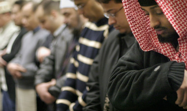 Muslim men pray Sunday, Feb. 1, 2004, in Seattle during Eid, which mark the end of the holy month of Ramadan. American muslim vote registration.