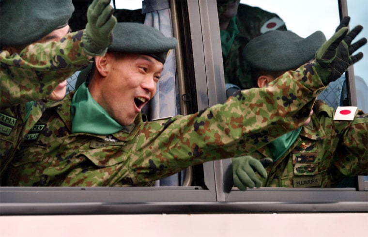 JAPANESE SOLDIERS WAVE FROM BUS AS THEY LEAVE ARMY GARRISON IN ASAHIKAWA