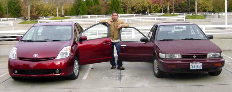 MSNBC.com's Miguel Llanos stands between his 1990 Nissan Stanza, right, and a 2004 Toyota Prius gas-electric hybrid.