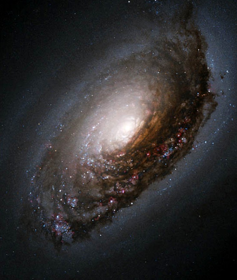 Hubble's image of the galaxy M64 shows fine details of a dark band of dust that cuts across the galaxy's otherwise-bright nucleus.