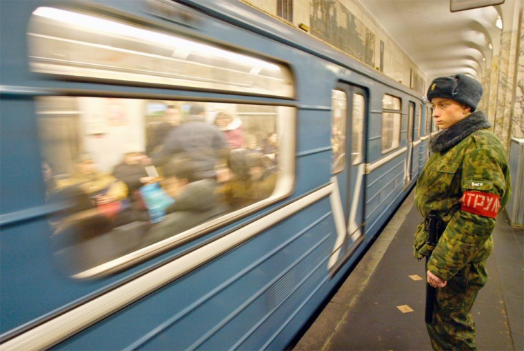 Russian Interior Ministry troops patrol the Avtozavodskaya subway station, the closest to the train explosion site, in Moscow on Saturday.