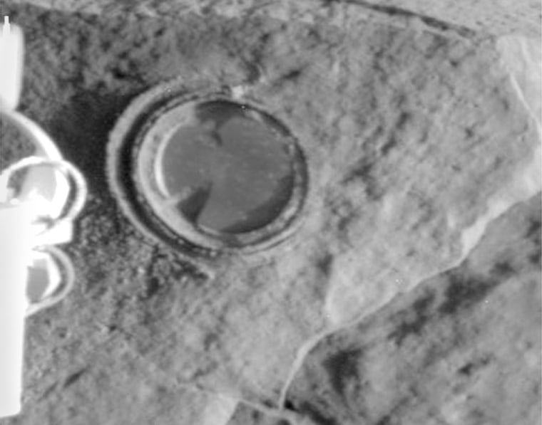 The round, shallow depression in this image resulted from history's first grinding of a rock on Mars. The rock abrasion tool on NASA's Spirit rover ground off the surface of a patch about 2 inches in diameter, to a depth of a tenth of an inch. 