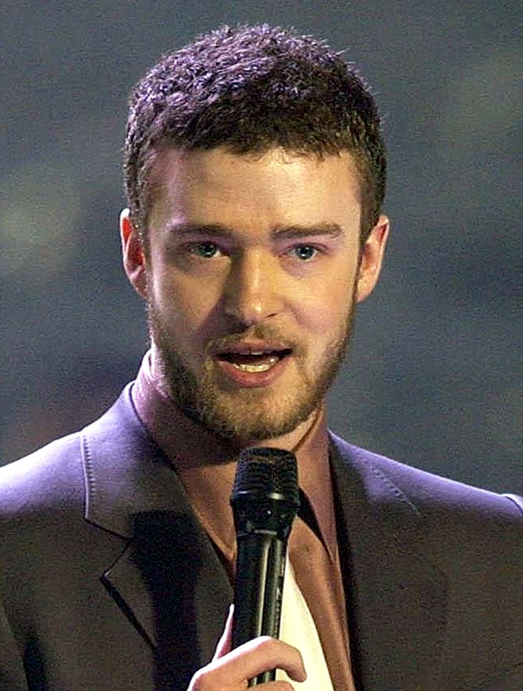 Singer Justin Timberlake accepts his award for Best International Male Solo Artist during the annual Brit Awards  in London Tuesday Feb. 17, 2004. (AP Photo/PA, Yui Mok)  **UK OUT:  MAGS OUT:  NO SALES**