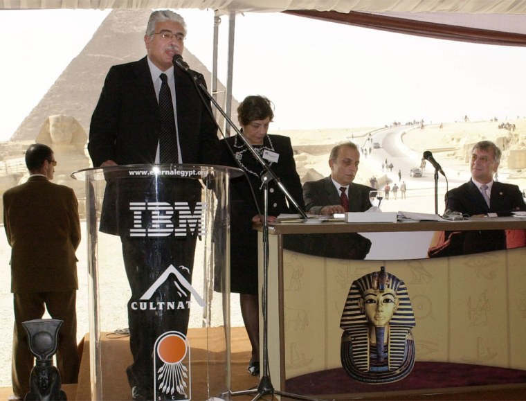 Egyptian communication minister Ahmed Nadeef addresses the media by Egypt's Giza pyramids, Tuesday, Feb. 24, 2004. Egypt's Ministry of Information Technology and IBM launched Eternal Egypt, an interactive Web site that is packed with information in English, Arabic and French. The three-year project used a US$ 2.5 million grant from IBM and showcases 5,000 years of Egypt's history, through the Pharaonic, Greco-Roman, Coptic and Islamic. Egypt hopes the site will help lure more tourists a main source of revenue. IBM General Manager for Europe, Mideast and Africa Hans Maerki is seated at right. (AP Photo/Hasan Jamali)
