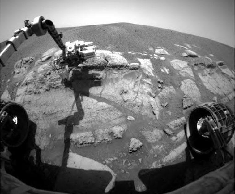 A picture from the Opportunity rover's front hazard avoidance camera shows the probe's robotic arm extended over a Martian outcropping nicknamed El Capitan.