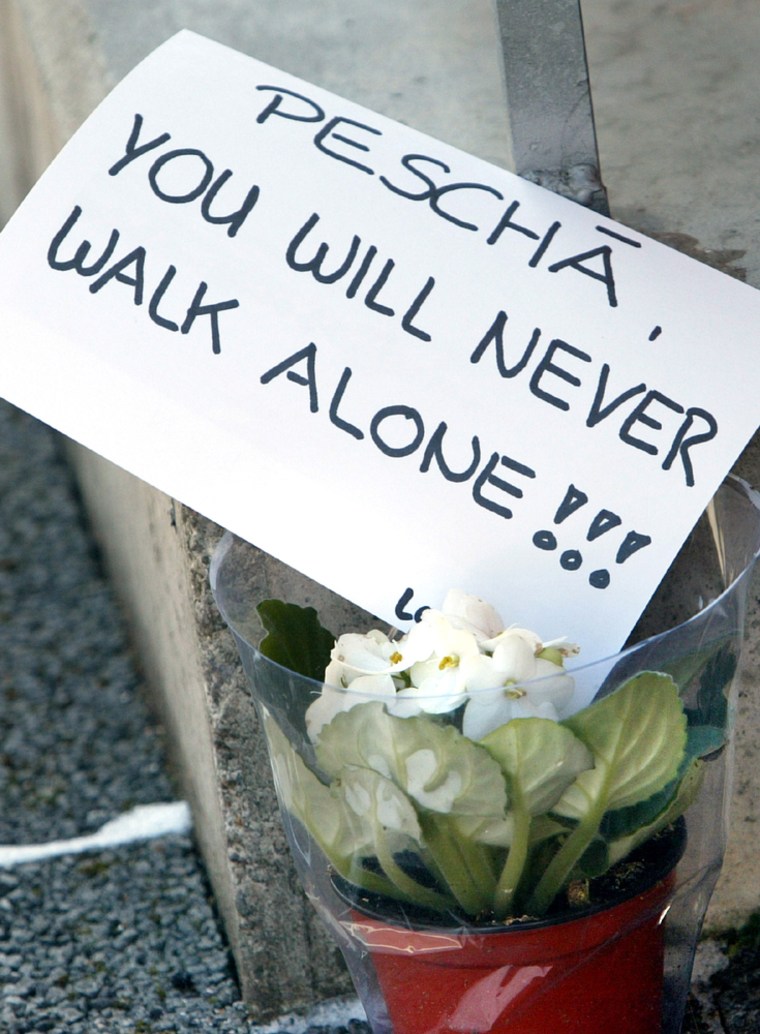 FLOWERS AND A CARD ADDRESSED TO VICTIM LAY AT ENTRANCE OF HOUSE