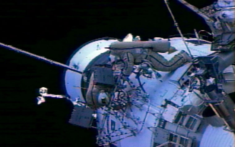 In video footage taken by one of the international space station's robotic cameras, Alexander Kaleri and Michael Foale work on the station's exterior during Thursday's spacewalk.