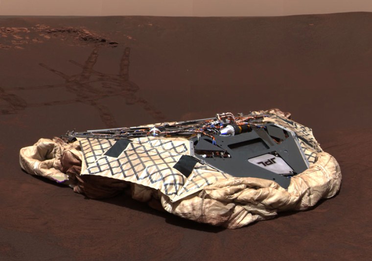 The Opportunity rover's panoramic camera looks back at the now-empty spacecraft lander, with rover tracks leading around rock formations in Meridiani Planum.