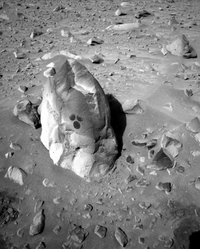 Three spots are dusted off on the rock known as Humphrey, revealing the darker surface beneath the dust. The Spirit rover brushed off the spots in preparation for drilling.