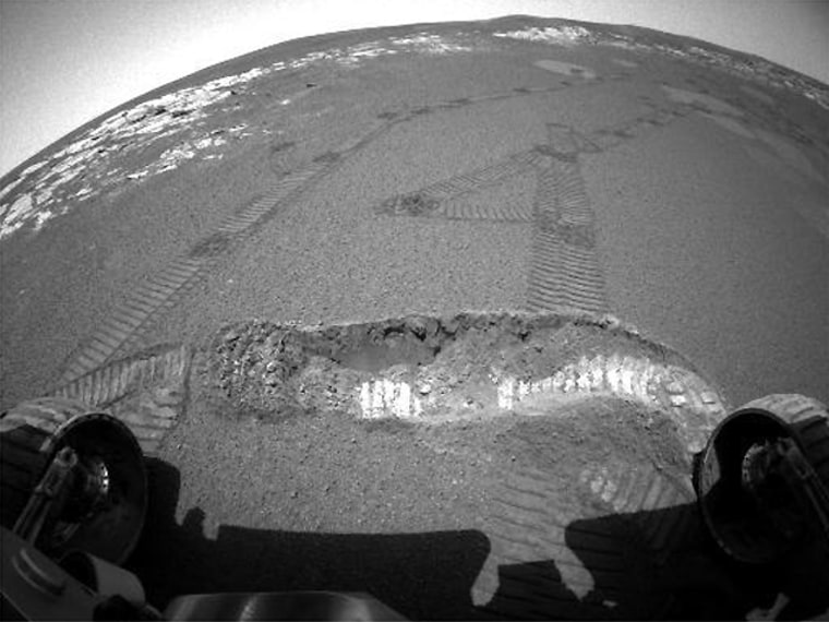 A wide-angle view taken by the Opportunity rover's hazard avoidance camera last month shows a trench dug in Martian dirt. Some scientists say the rover tracks suggest that the soil contains brine, with permafrost beneath the surface.