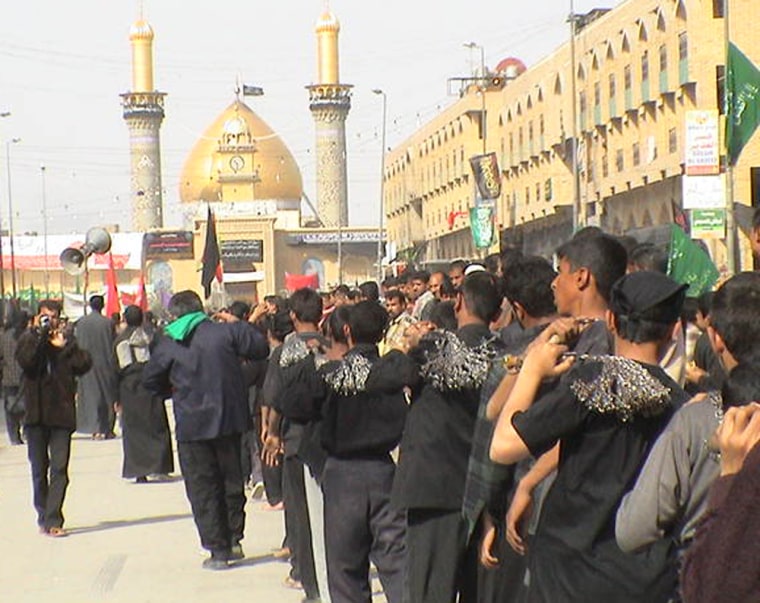 Shia men head toward the Iman Hussein shrine in Karbala.
