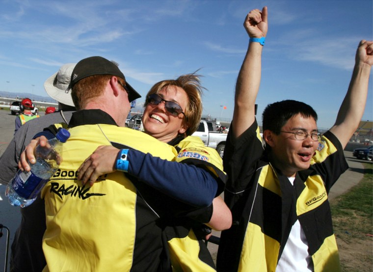 March 8, 2004 - California Speedway, Fontana, California - Team Caltech members Jeff Lamb (left), Jackie Wilbur and Haomaio Huang celebrate as \"Bob\", their autonomous 1996 Chevy Tahoe SUV leaves the starting line during qualifying trials for the DARPA Grand Challenge.