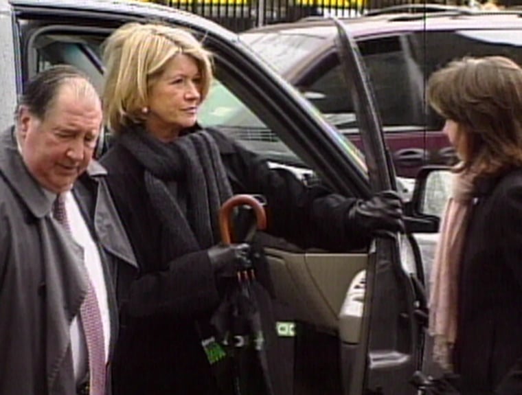 Wearing a black overcoat and carrying an umbrella, Martha Stewart arrived  at a federal courthouse in lower Manhattan Monday.