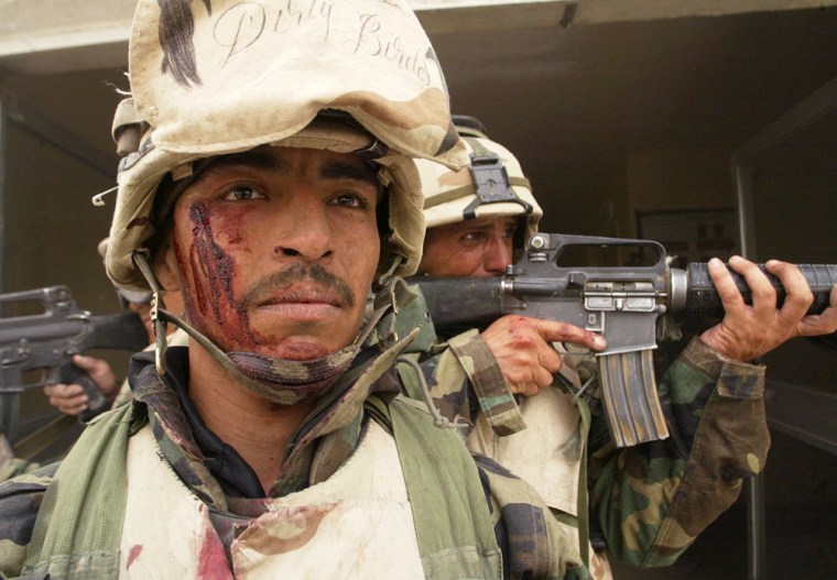 Marines from the 2nd Battalion, 8th Regiment emerge from a corridor during the takeover of a hospital in Nasiriyah on March 25, 2003, as the military faced unexpectedly stubborn resistance in the Iraqi city.