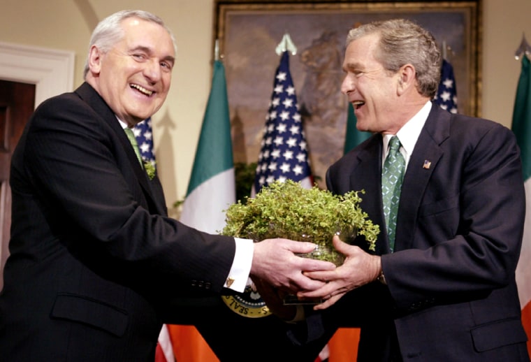 US PRESIDENT GEORGE W. BUSH IS HANDED SHAMROCK DURING A CEREMONY WITH BERTIE AHERN IN WASHINGTON