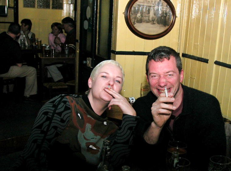 Sue Lyons, left, and David French smoke for a last night in The Idle Hour on Sunday in Cork City, Ireland.