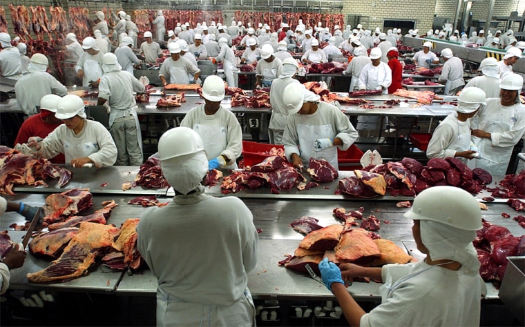 Brazil's beef export industry is one of the world's largest. Here, meat processors carve pieces for local and foreign consumption.