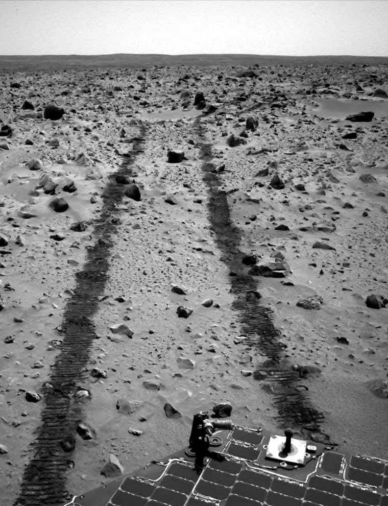 The Spirit rover's navigation camera snapped this picture looking back at its tracks on Monday, the 90th Martian day of its mission. The rover's sundial, which is used as a photo calibration target, is visible at lower right amid Spirit's solar panels.