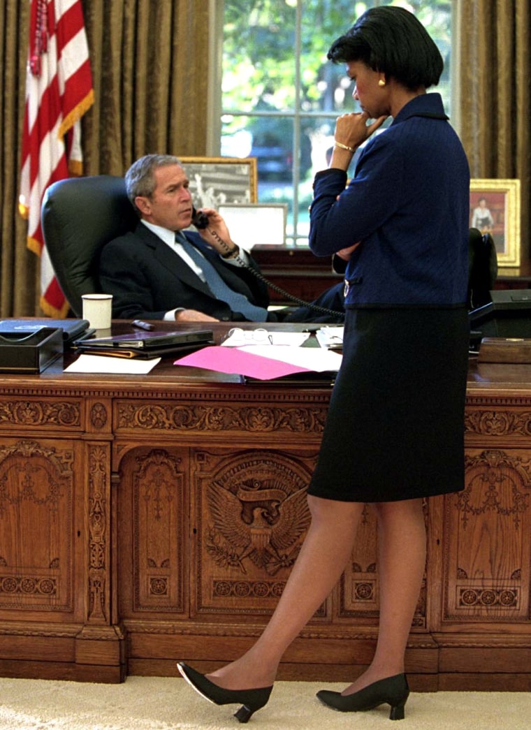As National Security Advisor Dr. Condoleezza Rice listens, President Bush holds a telephone conversation with Prime Minister Willim Kok of The Netherlands from the Oval Office Sept. 26.