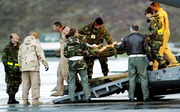 An unidentified injured U.S. soldier is carried on a stretcher at Ramstein Air Base on Thursday. Eight U.S. soldiers injured in combat in Iraq were flown out of Iraq to get medical treatment at the U.S. hospital in Landstuhl.  