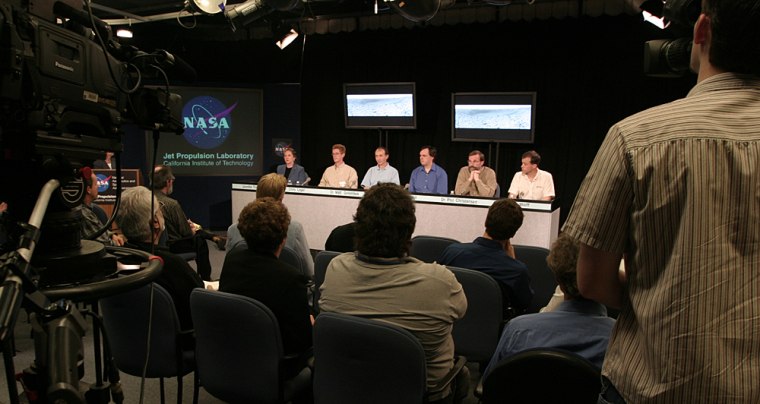 Mission manager Jennifer Trosper, rover planner Chris Leger and science team members Matt Golombek, Mark Lemmon, Philip Christensen and Michael Wolff take the stage for a news conference in the television studio at NASA's Jet Propulsion Laboratory.