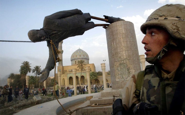 FILE PHOTO OF US SOLDIER WATCHES AS STATUE OF SADDAM HUSSEIN FALLS IN CENTRAL BAGHDAD