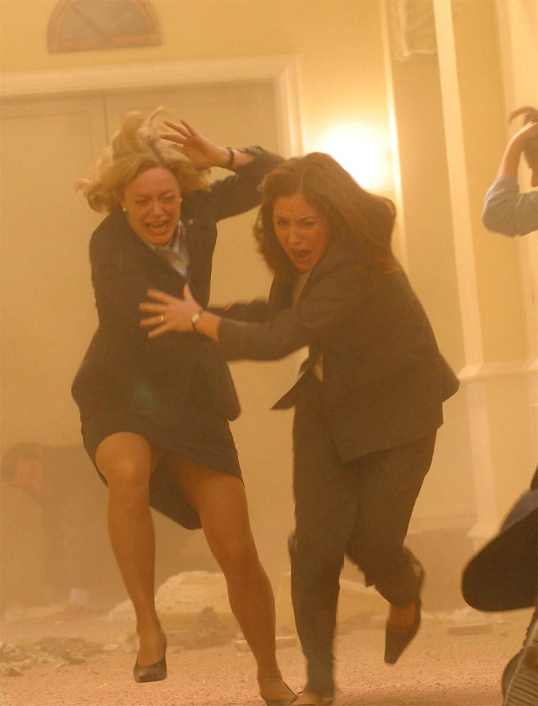 Rebecca Jenkins and Erin Karpluk run for cover in a scene from the NBC miniseries "10.5," which tells the story of an unprecedented West Coast earthquake. Scientists reacted to a screening of the show with a mixture of mirth and alarm.