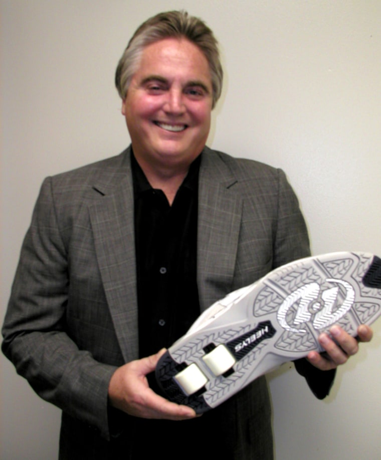 Roger Adams holding a Heelys shoe that was specially designed for Shaquille O'Neal — a size 22.