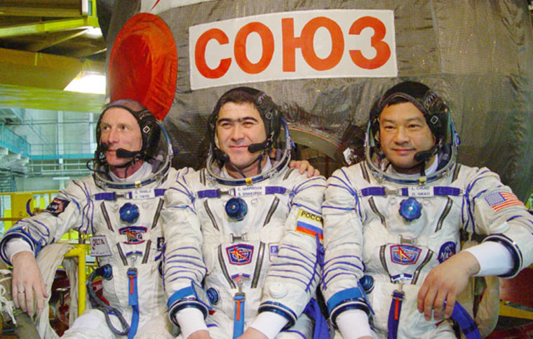 German astronaut Gerhard Thiele, Russian cosmonaut Salizhan Sharipov and NASA astronaut Leroy Chiao wear spacesuits during a training session this month. The Russians wanted Sharipov and Chiao to spend a year on the international space station, but NASA has objected. Thiele is to accompany Sharipov and Chiao to the station as a short-term visitor in October.
