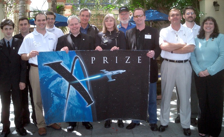X Prize teams meet in Los Angeles: from left, Dumitru Popescu of ARCA, Romania; Pablo DeLeon of DeLeon, Argentina; Oded Loebl of ILAT, Israel; Eric Meier of Space Transport, U.S.; Steve Bennett of Starchaser, U.K.; Burt Rutan of Scaled Composites, U.S.; Randa Milliron of Interorbital Systems, U.S.; Chuck Lauer of Rocketplane, U.S.; Brian Feeney of the Da Vinci Project, Canada; Neil Milburn of Armadillo, U.S.; Tim Pickens of HARC, U.S.; Lori Sheerin of Canadian Arrow.