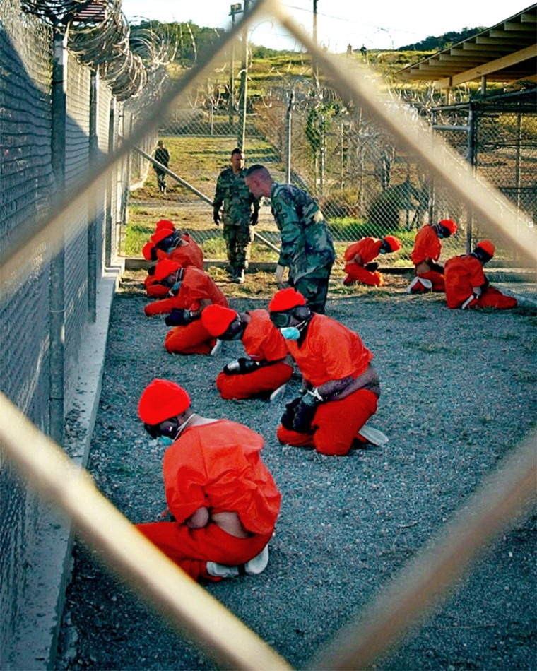 Detainees sit in a holding area at Guantanamo. 