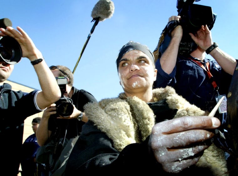 AN ABORIGINAL WOMAN, KNOWN AS MOOPOR, POINTS A KANGAROO BONE AT AUSTRALIAN PRIME MINISTER HOWARD IN COLAC