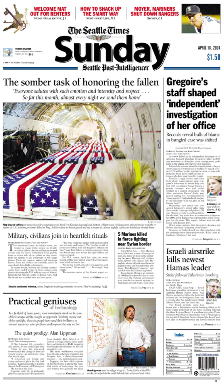 The front page of the Sunday, 18 April 2004, edition of the Seattle Times displays the lead picture of US flag-draped coffins containing the bodies of US soldiers killed in Iraq being secured inside a cargo plane 07 April 2004 at Kuwait International Airport. The image was used amid debate over the US administration's strict prohibition on the media taking photographs of soldiers' coffins being offloaded at US military bases. The photograph was by Tami Silicio, a Seattle-area resident working on contract at the US military section of Kuwait International Airport, who was also dismissed from her job 21 April 2004. == CREDIT MANDATORY: THE SEATTLE TIMES VIA AFP ==