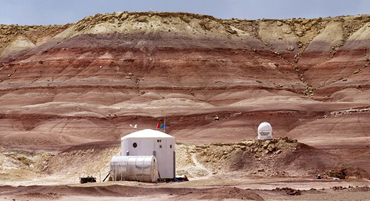 ** ADVANCE FOR WEEKEND EDITIONS, APRIL 24-25 ** The Mars Desert Research Station lies at the base of a hill Monday, April 19, 2004, northwest of Hanksville, Utah. The red landscape of cracked dirt, loose soil, folling hillss and jtting cliffs bear a striking resemblance to the Mars photographs retrieved from NASA's rovers. (AP Photo/Douglas C. Pizac)