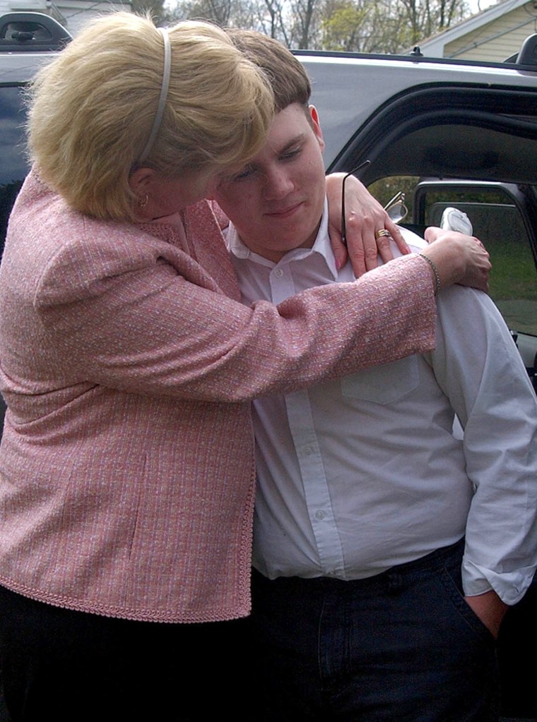 CRIME VICTIM PATRICK HOLLAND RECEIVES A HUG FROM FOSTER AUNT