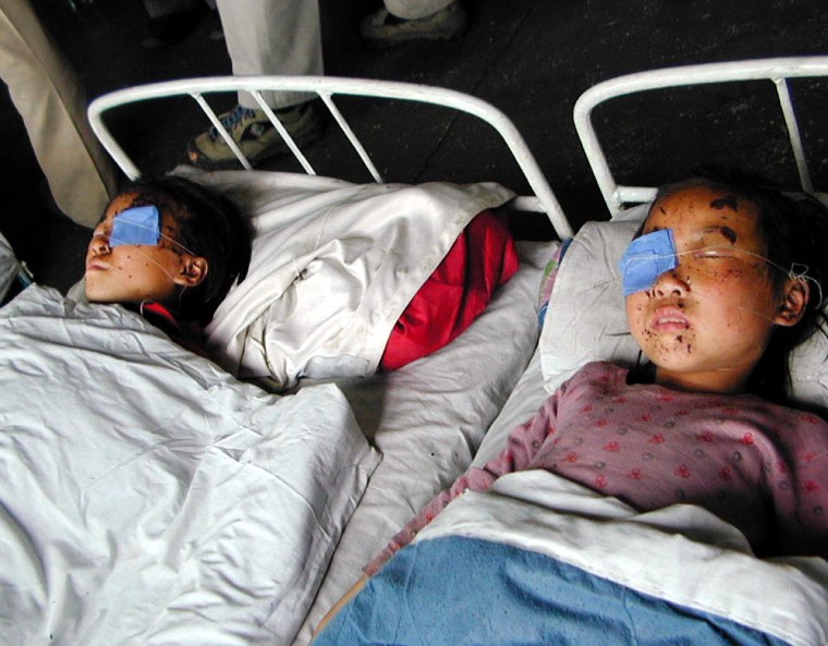 Two children injured in the rail explosion lie in beds at the People's Hospital in Sinuiju, North Korea.
