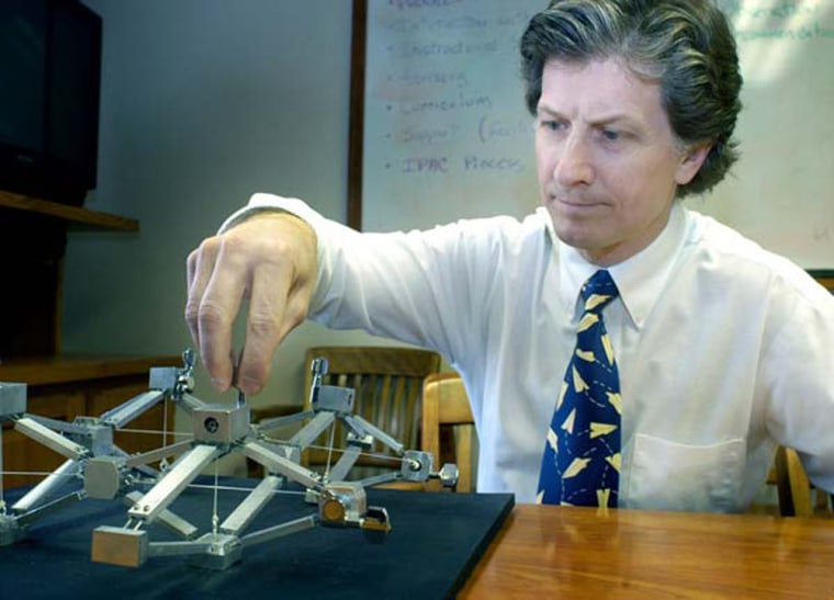 Aerospace engineer George Lesieutre, of Pennsylvania State University, with a tabletop model of the compliant cellular truss structure designed to change an aircraft's wing shape in flight.
