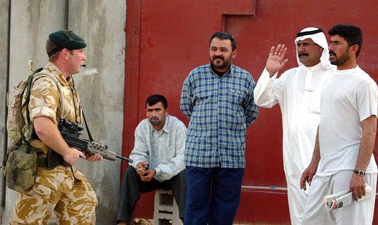 A British soldier is greeted by Basra residents while on patrol in late March.