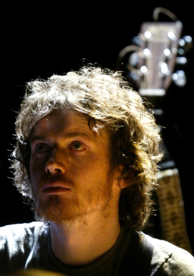 Singer-songwriter Damien Rice sits on stage while performing at the Fox Theater in Boulder, Colo., Tuesday, March 23, 2003. Rice, a folk-oriented Irishman who is selling out small theaters on a U.S. spring concert tour, scored a gig last year at the home of a Hollywood agent to introduce his music to the movie community. (AP Photo/Jack Dempsey)