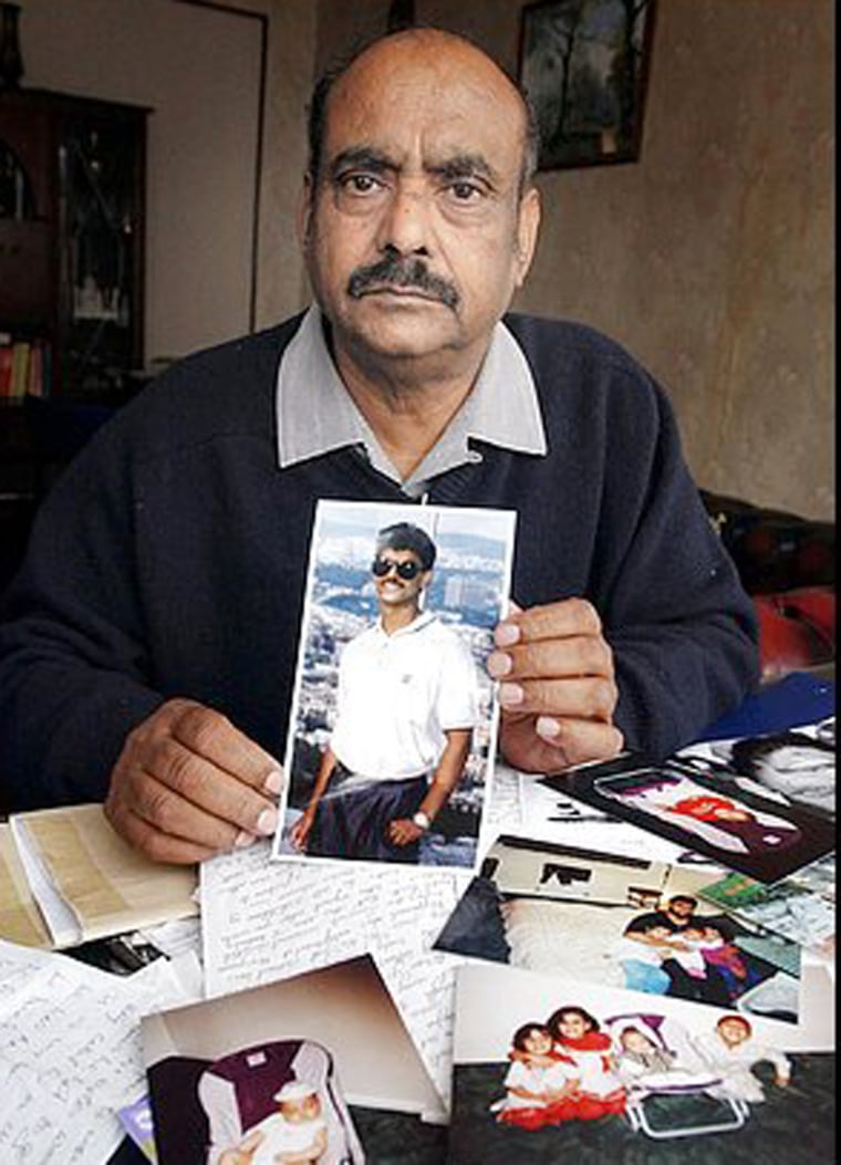 Azmat Begg holds a photo of his son, British detainee Moazzam Begg, who has been in Guantanamo for two years.