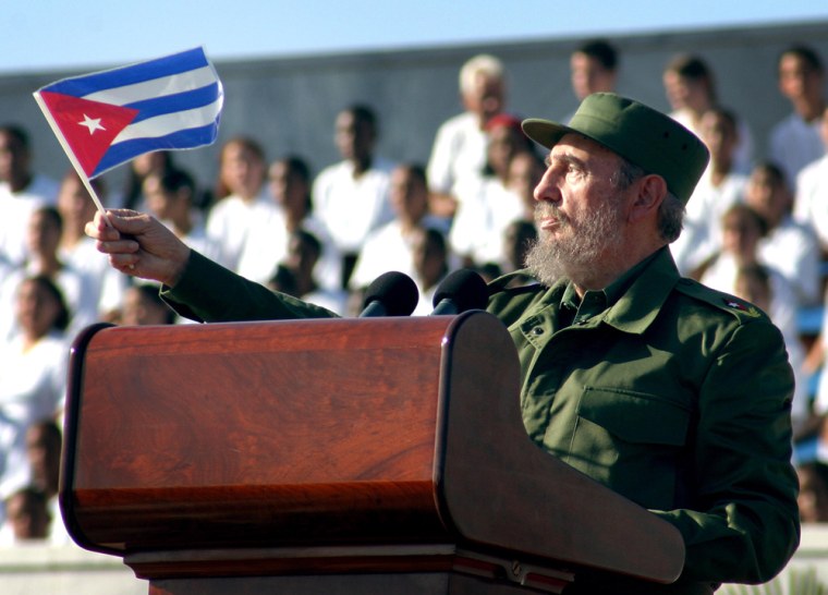 Cuban President Fidel Castro waves a Cuban flag after his May Day speech Saturday at the Revolution Plaza in Havana.