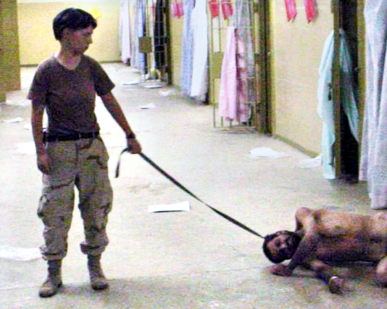 SOLDIER HOLDS A LEASH OF AN IRAQI PRISONER IN IMAGES RELEASED BY THE WASHINGTON POST