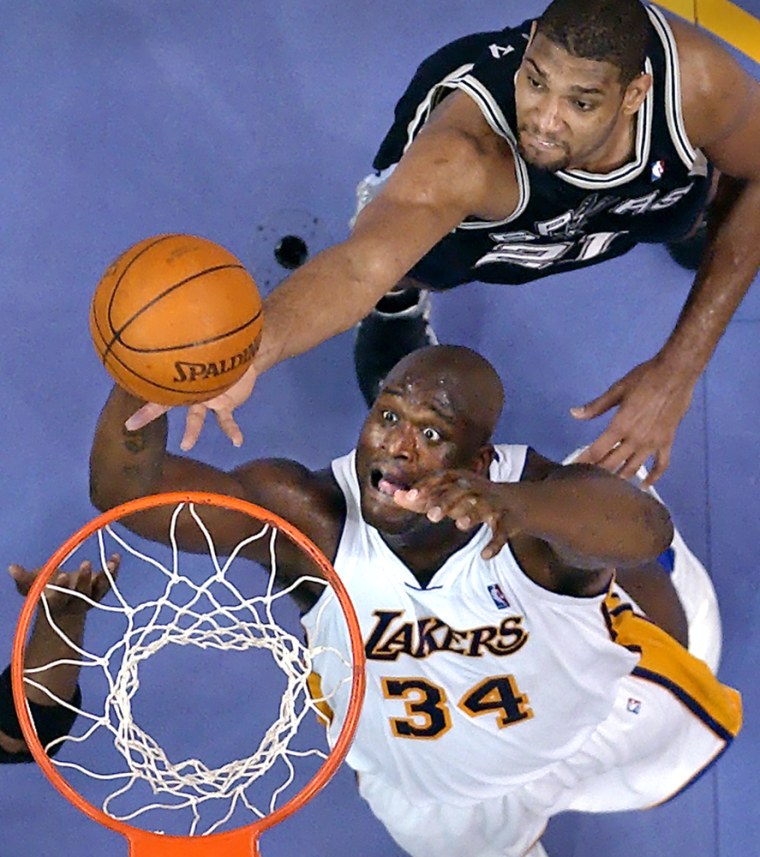 Lakers center Shaquille O'Neal dunks in front of San Antonio's Tim Duncan. The Lakers beat the Spurs on Sunday in Los Angeles.