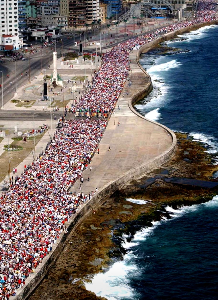 AERIAL VIEW OF CUBANS MARCHING ALONG HAVANA'S SEAFRONT