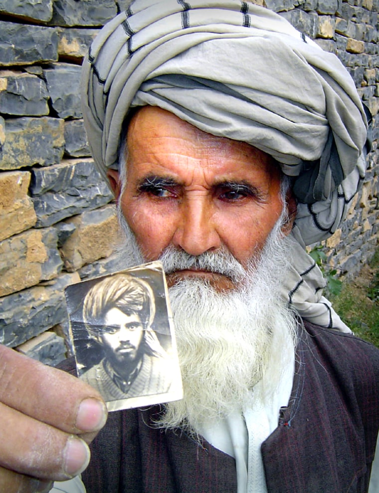 KHIALI GUL'S FATHER HOLDS A PICTURE OF HIM IN YAQUBI