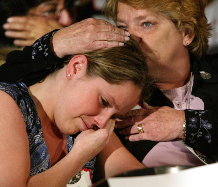 Melissa Ielpi, left, is comforted by her mother Anne, of Great Neck, N.Y., as they listen to testimony and see images during Sept. 11 commission hearings in New York, Tuesday May 18, 2004. They lost firefighter Jonathan Ielpi, Melissa's brother and Anne's son, in the World Trade Centere attack.(AP Photo/Gregory Bull)