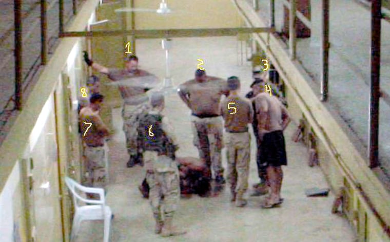 This photo provided by attorney Guy L. Womack, who is representing Army Spc. Charles A. Graner Jr., was purportedly taken at Abu Ghraib prison. The defense claims the photo shows unidentified military intelligence personnel, marked as No. 4, 5, 7 and 8. Graner, identified as No. 1 in this photograph, faces criminal charges for alleged abuse of Iraqi prisoners at the prison.