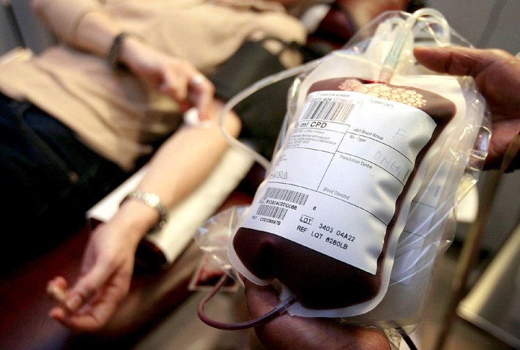 DONOR GIVES BLOOD AT A NATIONAL BLOOD SERVICE CENTER IN LONDON