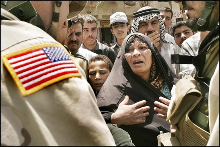 Om Hyder talks to U.S. soldiers about problems in her Baghdad neighborhood during a ground-breaking ceremony for a sewer project. 